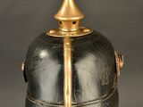 a close up of a helmet on a stand on a gray background