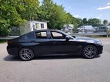 a picture of a black bmw car parked in a parking lot