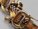 an image of a close up of a gold bracelet with a lock on it