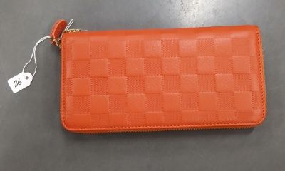 un petit portefeuille orange muni d'une étiquette