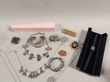 a lot of jewelry sitting on a white surface