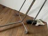 an image of a clothes rack on a wooden floor
