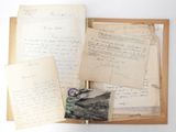 an old book with a bunch of papers on top of it