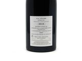 a bottle of wine that is sitting on a table