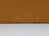 a brown box with a yellow label on it sitting on a white surface