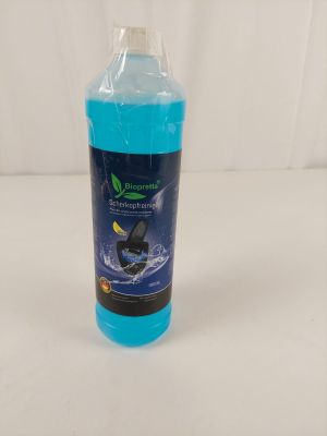 a bottle of blue liquid sitting on top of a white table