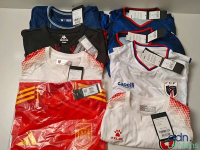 several soccer shirts are sitting on a table with labels on them
