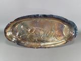 une assiette en argent sur laquelle est représenté un homme et une femme