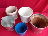 many cups and bowls sitting on a red cloth