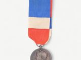 a silver medal with a red, white and blue ribbon around it