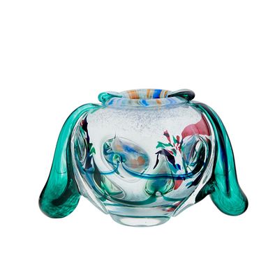 a glass teapot with a bird design on it