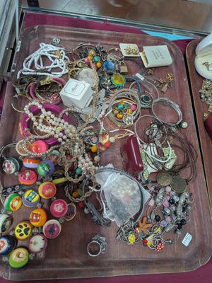 deux plateaux de bijoux posés l'un à côté de l'autre sur une table