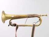 a brass trumpet with a leather strap attached to it