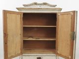 a small cabinet with a door open on a white surface