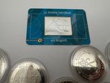 a close up of a set of five coins with a stamp on it