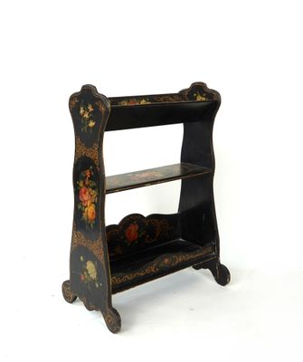 a black shelf with a floral design on it