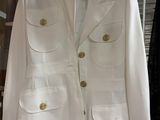 a white jacket hanging on a rack in a store