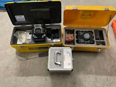 a yellow case with a camera and other items in it
