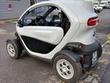 a small car that is parked on the side of the street