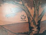 a vase with a painting of a tree and a bird on it