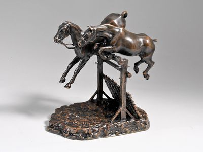 bronze statue of a horse and rider jumping over a bridge