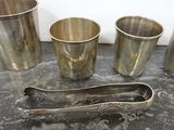 four cups and a spoon sitting on a table