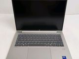 an open laptop computer sitting on top of a white table