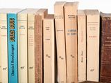 many books that are lined up on a shelf