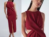 une femme vêtue d'une robe rouge, dos nu et fendue sur le côté