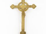 a gold cross on a white background with a white background