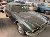 many old cars that are parked in a parking lot