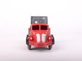 a red toy truck that is sitting on a white surface