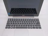 a laptop computer sitting on top of a white table