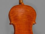 an old violin with a wooden back and bow on a gray background
