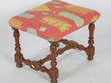 a small wooden stool with a colorful seat on it