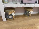 two vases that are sitting on the floor