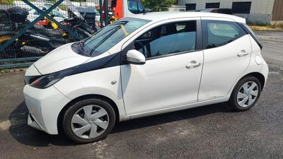 a picture of a small white car parked in a parking lot