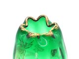 a green glass vase with a gold decoration on it
