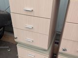 four drawers and a chair in a room