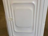 an image of a white washer sitting on top of a counter