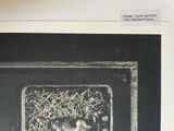 a black and white photo of a cat sitting in an oven