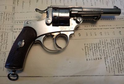 un pistolet posé sur une feuille de papier