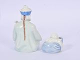 a figurine of a man and a woman standing next to each other