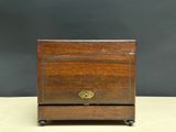 an old wooden box with a brass lock on it