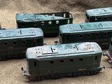 six toy trains sitting on the ground next to each other