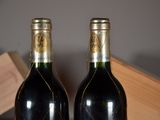 two bottles of wine that are sitting on a table