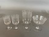 several empty wine glasses are lined up on a table