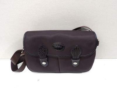 purple leather messenger bag with black leather handles on white background