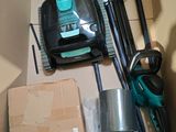 a box with a vacuum and other household items in it