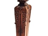a small wooden clock on a pedestal on a white background